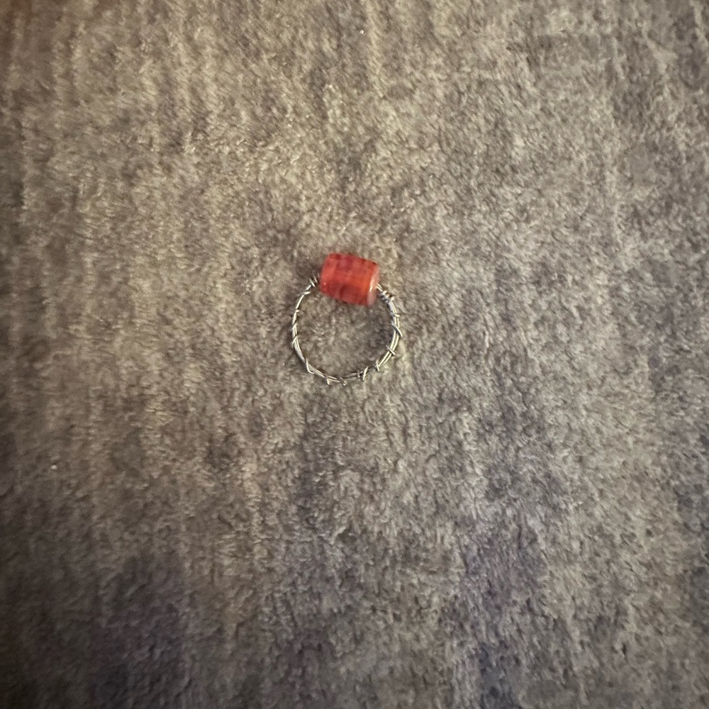 This flexible ring is what you want!! It’s a sterling silver with a orange bead